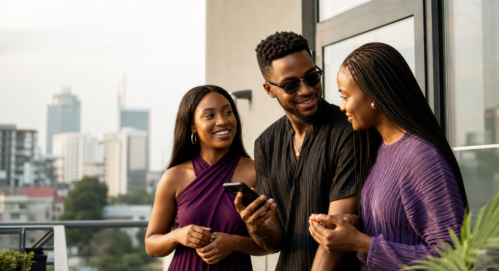 Three Nigerian friends sharing a moment around a phone